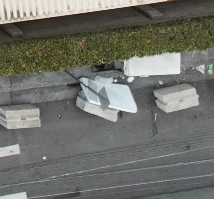 A closer view of the bulky items beside concrete barriers shown in view 6