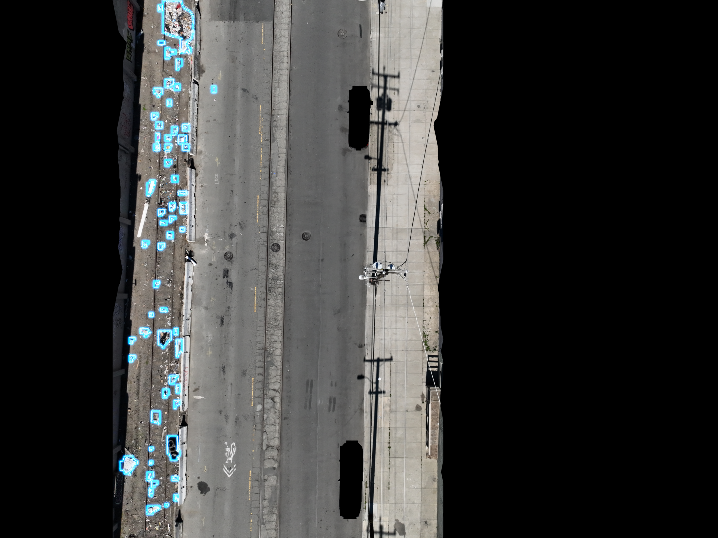 Aerial survey showing comprehensive detection of dumping along a city sidewalk and curb