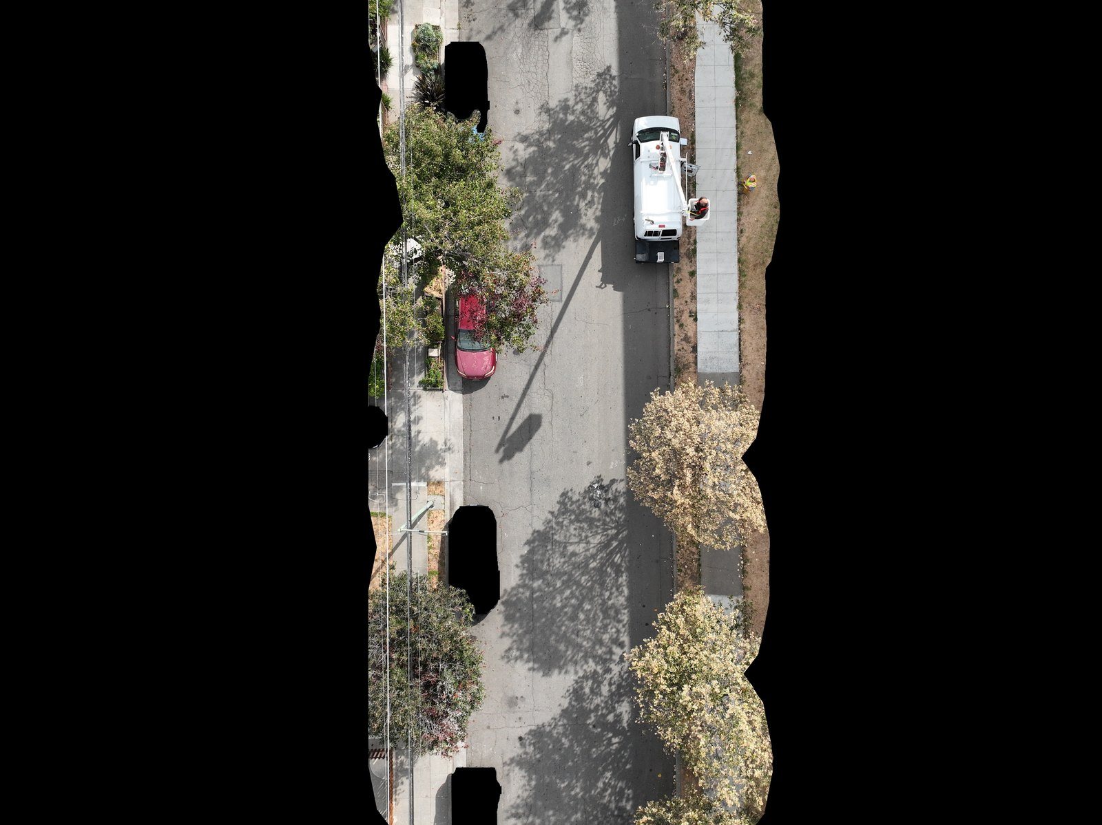 A straight-down aerial frame of a street with a utility truck below